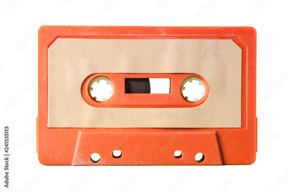 An old vintage cassette tape from the 1980s (obsolete music technology). Vivid colors: dark orange plastic body, sand pale pink label.
