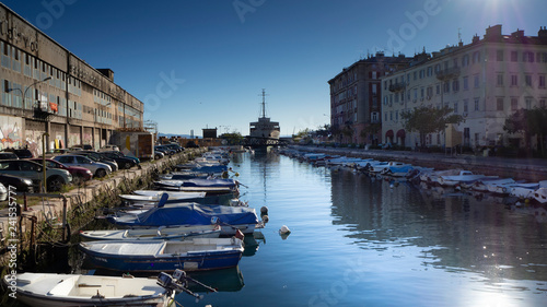 Boats and Urban Life at Waterfront of the River Rječina in Harbor City Rijeka, Croatia photo