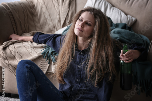 Depressed woman drinking al...