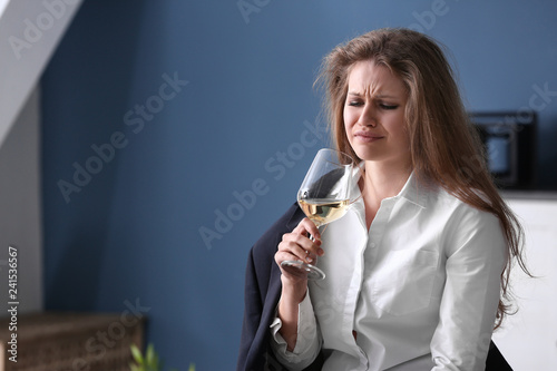 Depressed woman drinking al...