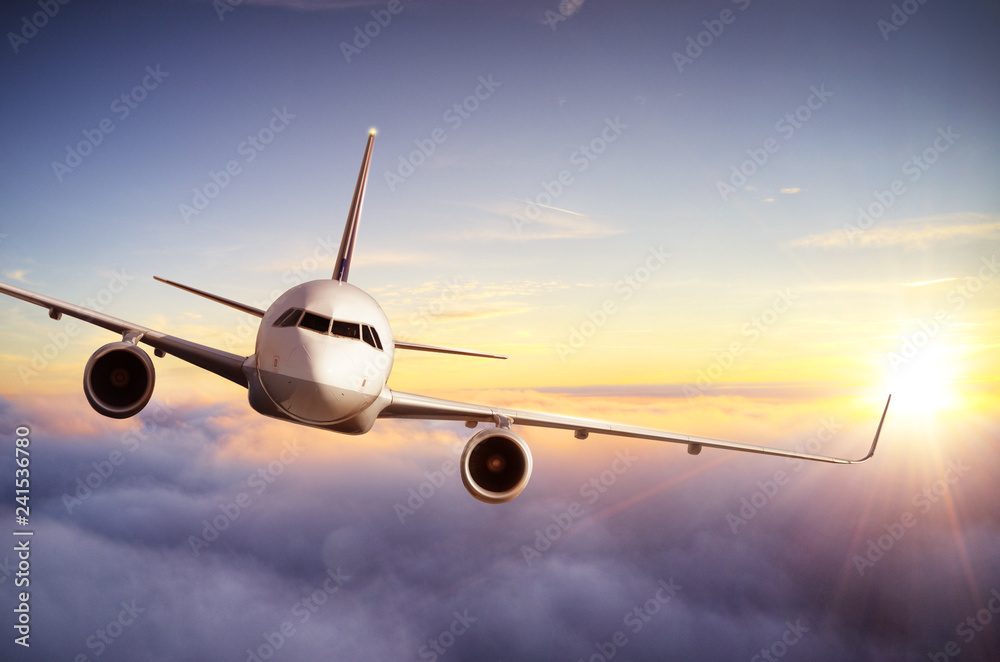 Fototapeta premium Passengers commercial airplane flying above clouds