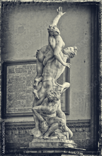 Statue The Rape of the Sabine Women shows the moment one of the women was stolen from her husband, with the captor crushing him against a rocks. Black White Photography. Sculptures in Florence, Italy