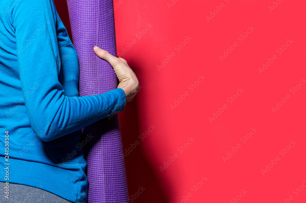 Sporty yoga girl with yoga mat isolated over bright background - obrazy, fototapety, plakaty 