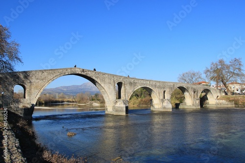 Old famous stone bridge at the city of Arta at the banks of Arachthos river in Epirus Greece