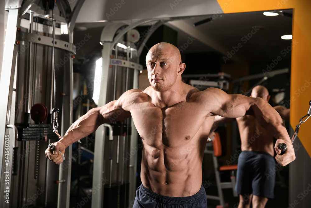 Muscular man training in gym Muscular man training in gym