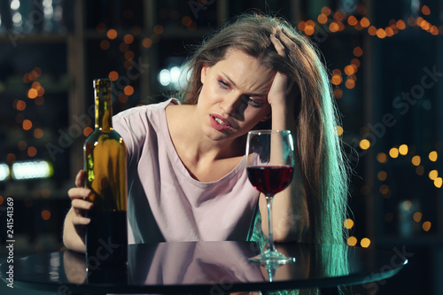 Young woman drinking alcoho...