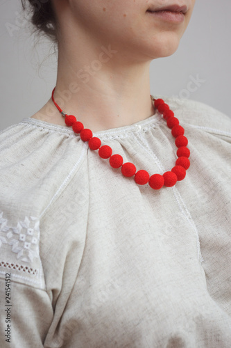 Red necklace of felt wool on girl model
