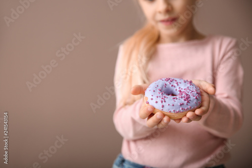 Cute little girl with donut...