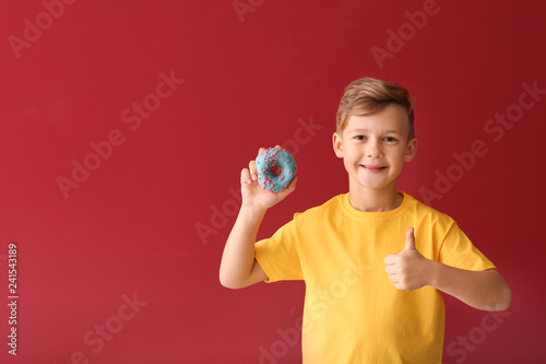 Cute little boy with donut ...