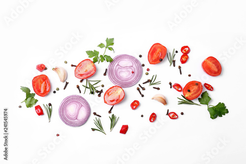 Cut vegetables, herbs and spices on white background, flat lay