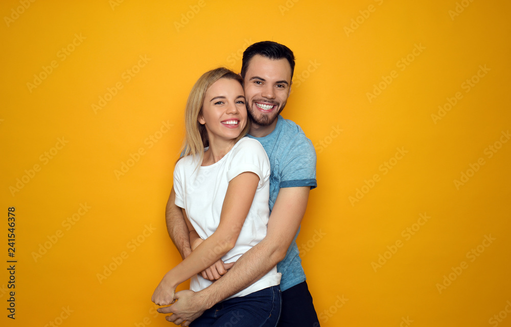Stylish young couple on color background Stylish young couple on color background