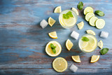 Composition with fresh lemonade on wooden background