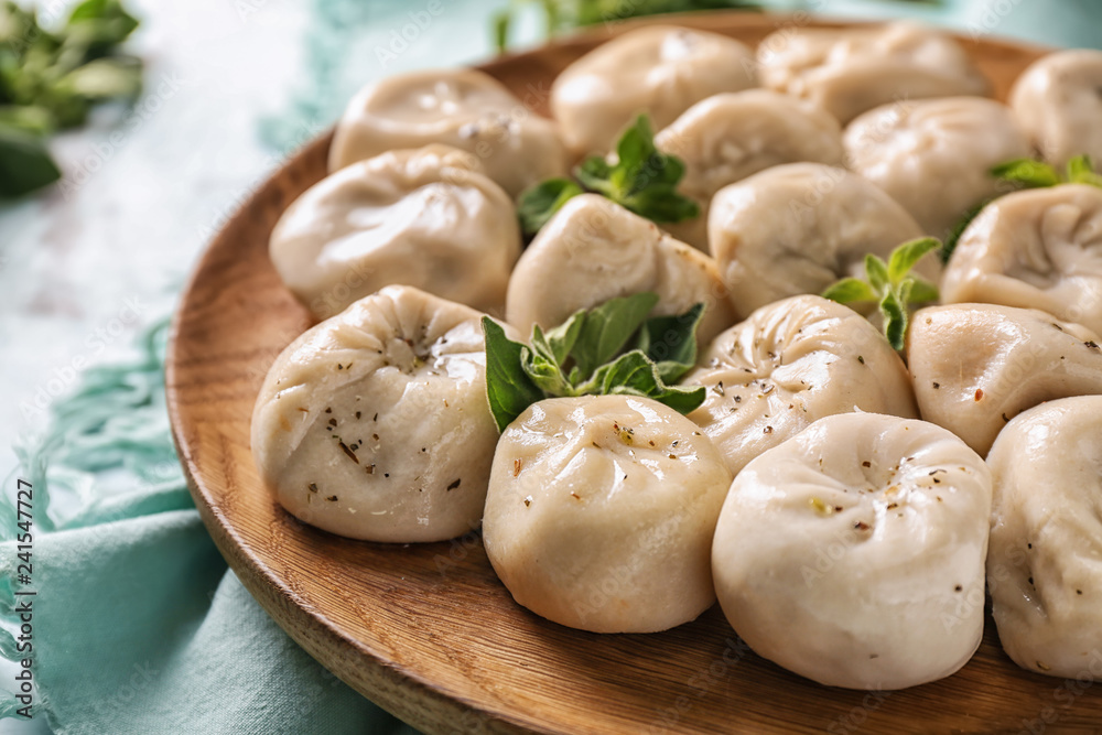 Plate with tasty Chinese dumplings on table, closeup Plate with tasty Chinese dumplings on table, closeup