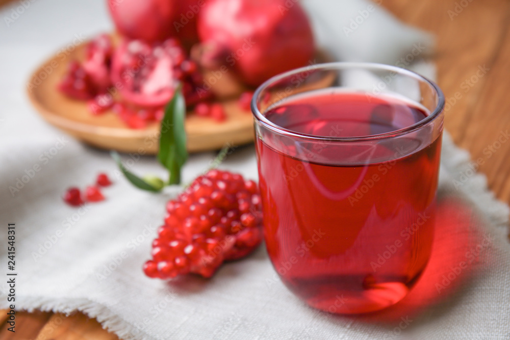 Glass of tasty pomegranate juice on table Glass of tasty pomegranate juice on table