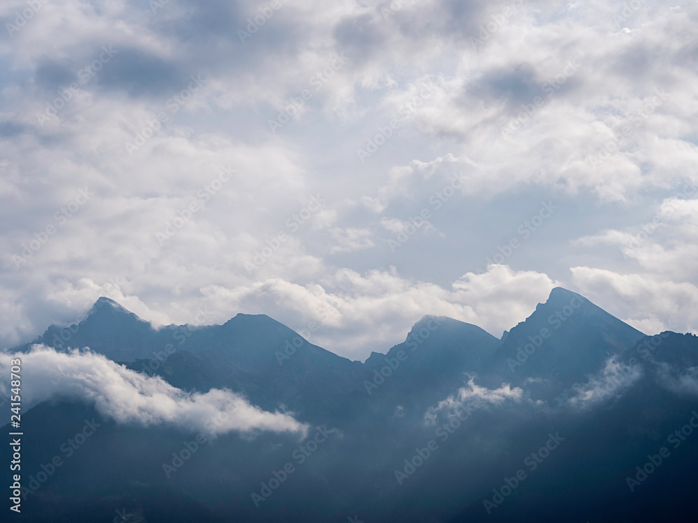 Mountain chain surrounded by clouds