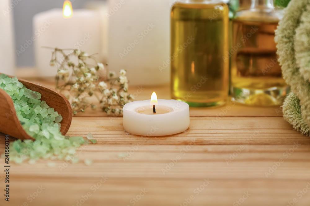 Burning candle on table in spa salon