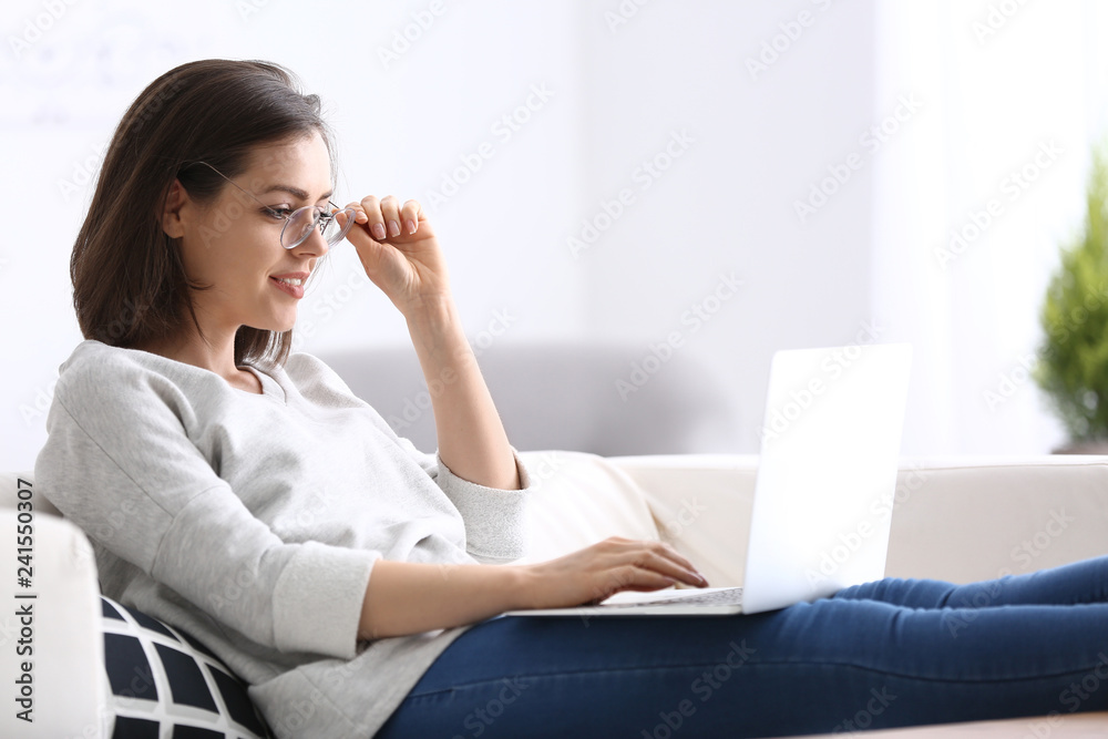 Young woman working with laptop at home Young woman working with laptop at home