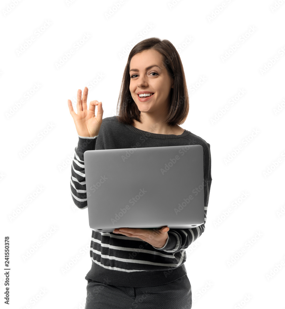 Young woman with laptop showing OK gesture on white background Young woman with laptop showing OK gesture on white background