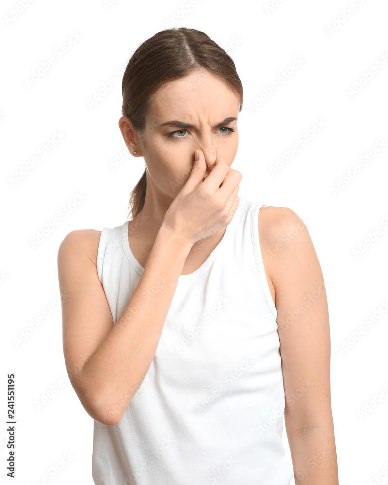 Beautiful young woman feeling smell of sweat on white background. Concept of using deodorant Beautiful young woman feeling smell of sweat on white background. Concept of using deodorant