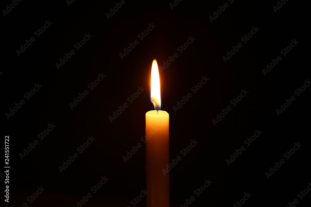 Beautiful burning candle on dark background Beautiful burning candle on dark background