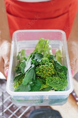 Baby broccoli soaking in plastic box