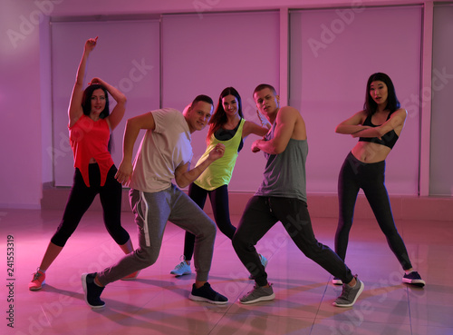 Team of young people dancing in studio