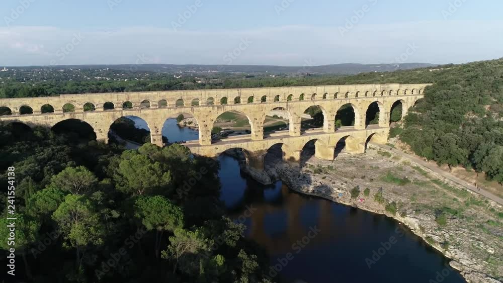 Aerial footage of Pont du Gard is an ancient Roman aqueduct that crosses the Gardon River near the town of Vers-Pont-du-Gard in southern France and popular tourist destination 4k high resolution