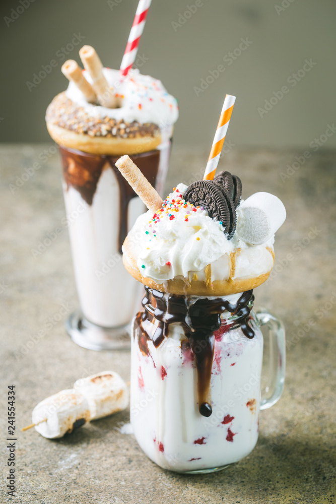 Milk Monster Shakes or Freak Shake. Big Crazy Milkshake or Freakshake with  Treats and Sweets Mix. Sweet Drink Dessert Collection in a glasses Photos |  Adobe Stock