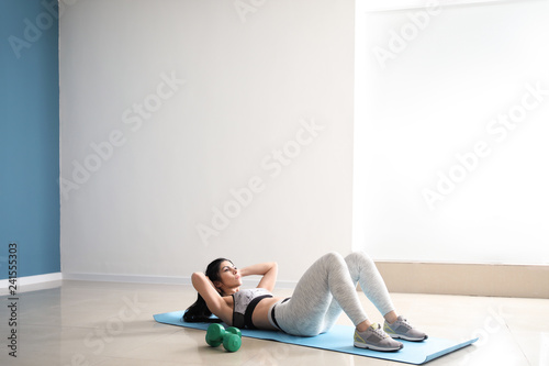 Sporty muscular woman training in gym