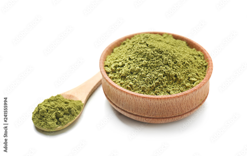 Bowl and spoon with powdered matcha tea on white background Bowl and spoon with powdered matcha tea on white background