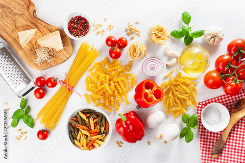 Wallpaper Mural ingredients for italian cousine flat lay, pasta spaghetti penne fusilli tomato oil vegetables Torontodigital.ca