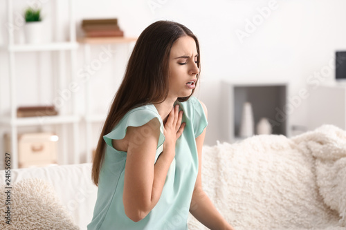 Obraz na płótnie Young woman having asthma attack at home