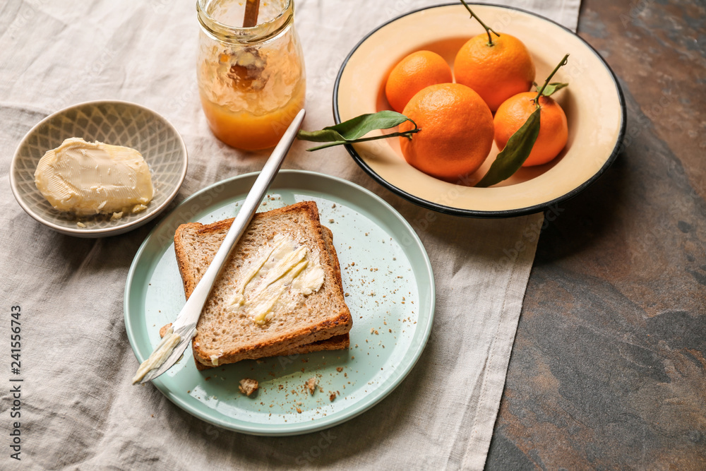 Bread with butter and tasty tangerine jam on table Bread with butter and tasty tangerine jam on table