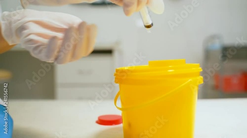 Container for disposing of used syringes.