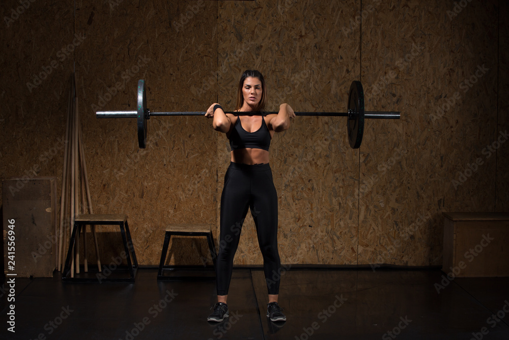 Woman performs deadlift with weight in the gym Woman performs deadlift with weight in the gym