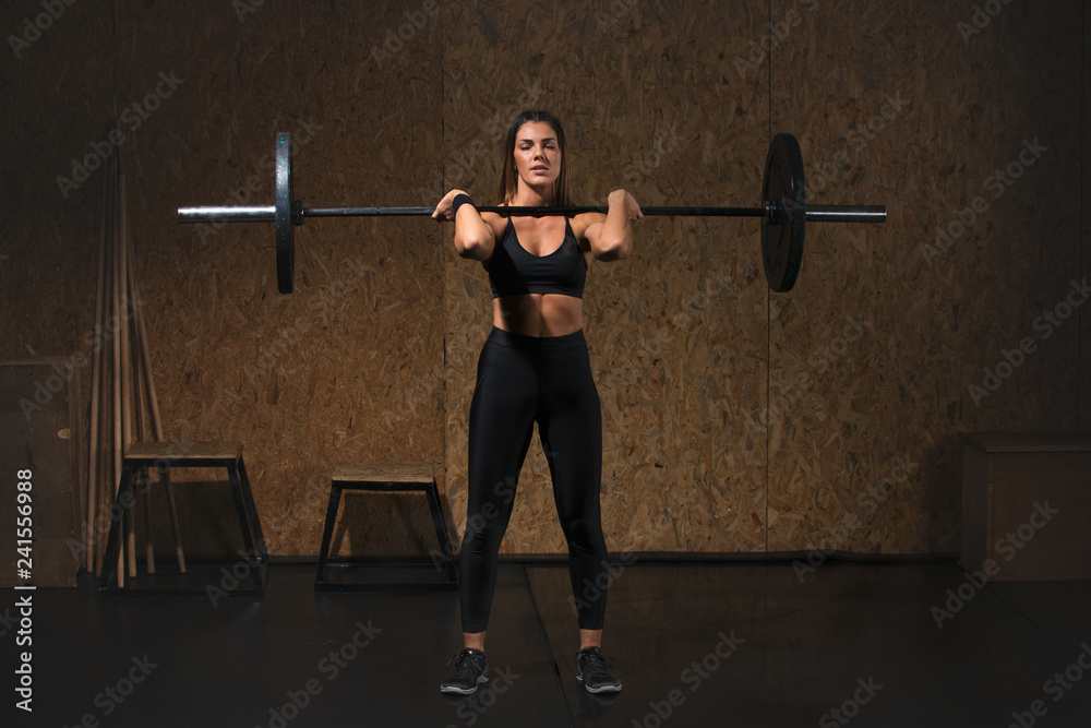 Woman performs deadlift with weight in the gym Woman performs deadlift with weight in the gym