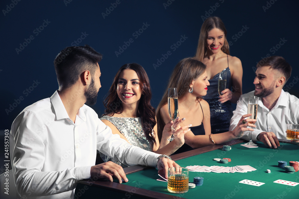 Group of people playing poker in casino Group of people playing poker in casino