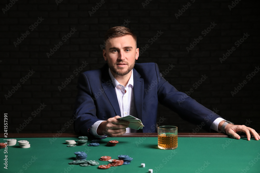 Handsome poker player at table in casino Handsome poker player at table in casino