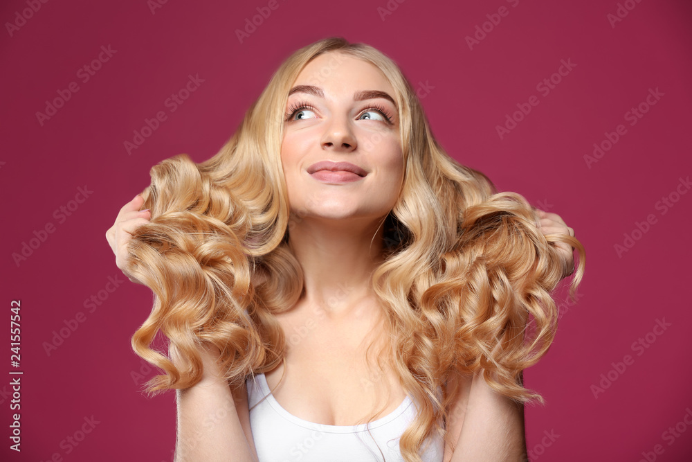 Young woman with beautiful curly hair on color background Young woman with beautiful curly hair on color background