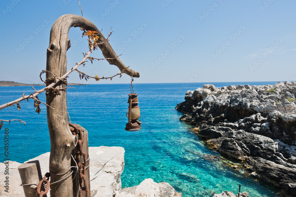 Fototapeta premium Old dusty and rusty lantern above boat dock near Marmara beach, island of Crete, Greece