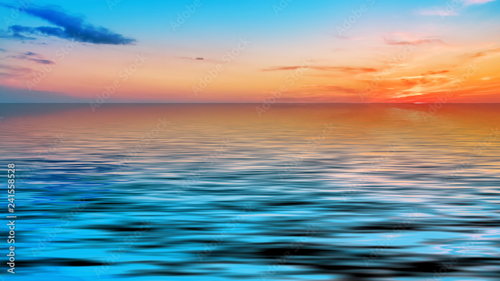 Magnificent bright sunset over the calm surface of the sea.