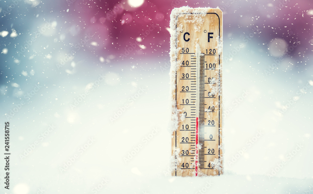 Obraz premium Thermometer on snow shows low temperatures in celsius or farenheit