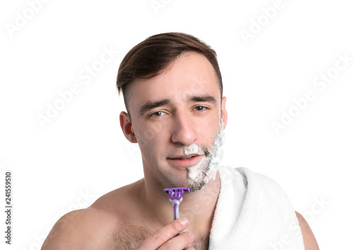 Handsome man shaving agains...