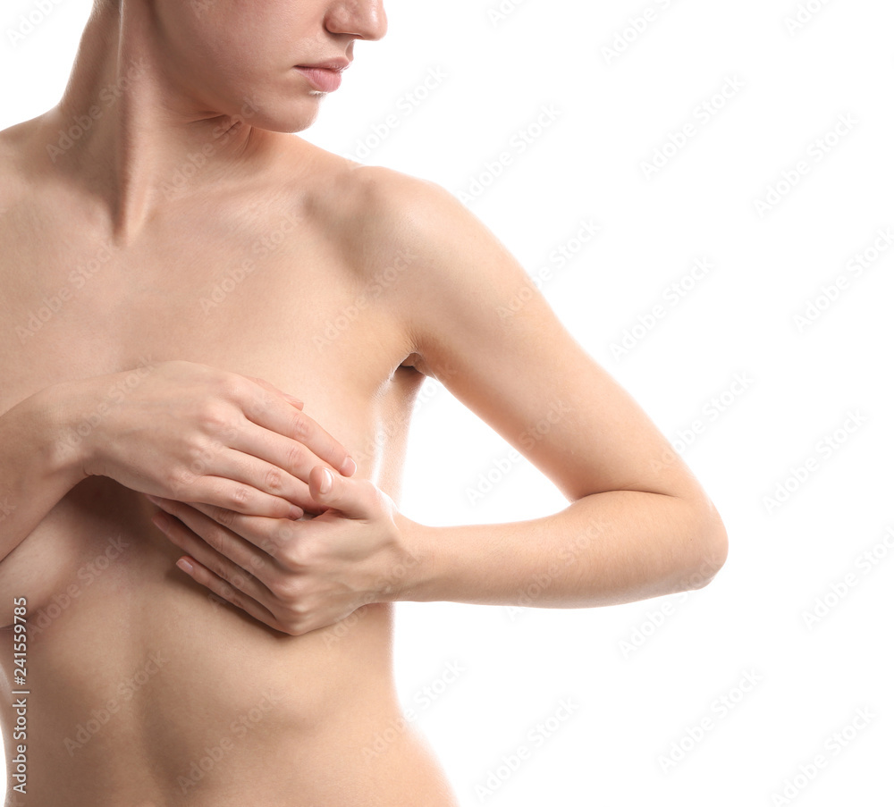 Young woman checking her breast on white background. Cancer awareness concept Young woman checking her breast on white background. Cancer awareness concept