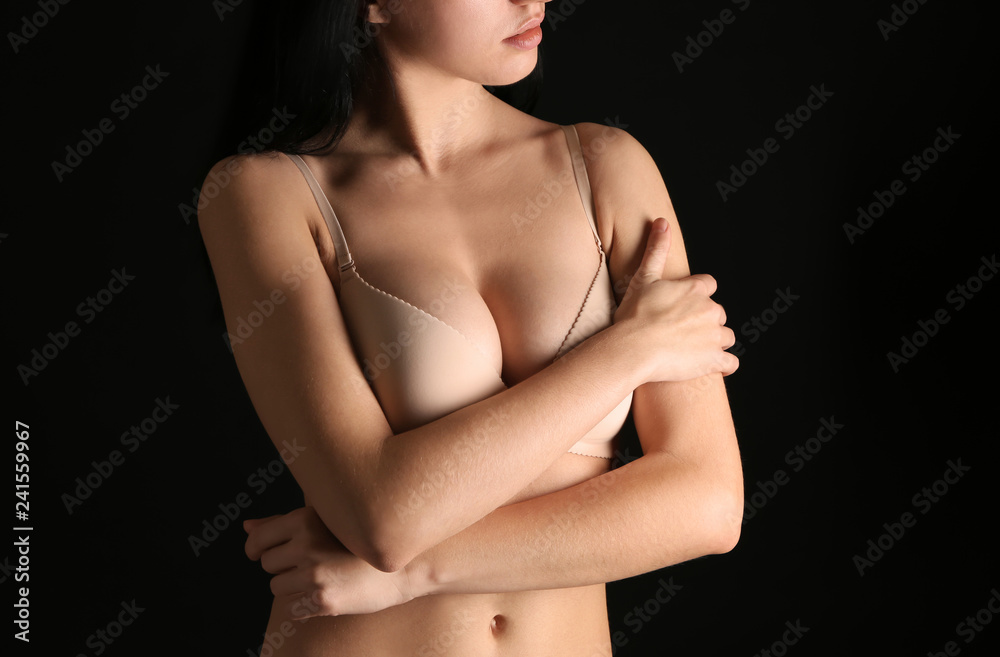 Young woman with beautiful breast on dark background, closeup Stock Photo