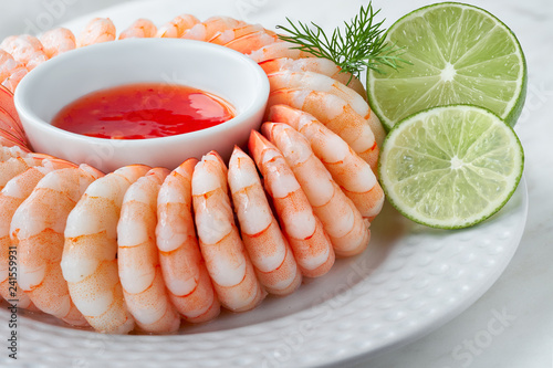 Close-up on shrimp ring with sweet chili sause with dill and lime