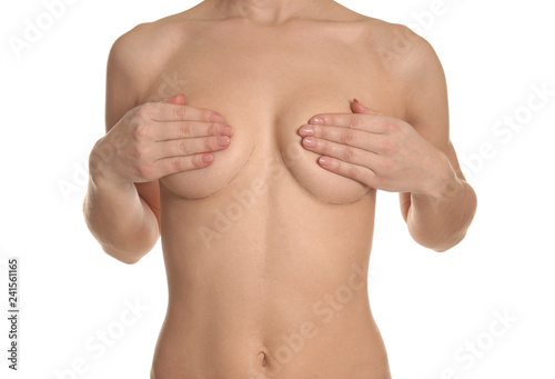 Naked woman on white background. Concept of breast augmentation