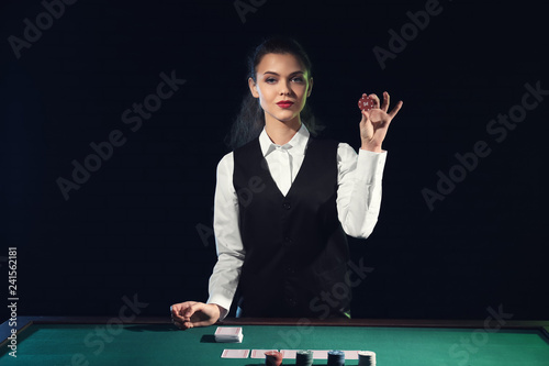 Beautiful female banker at table in casino photo