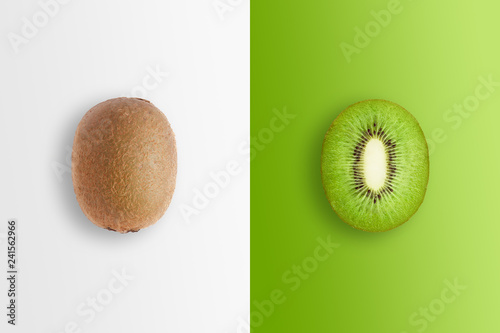 Fotografia, Obraz Creative background, kiwi and kiwi slices on a white and green background