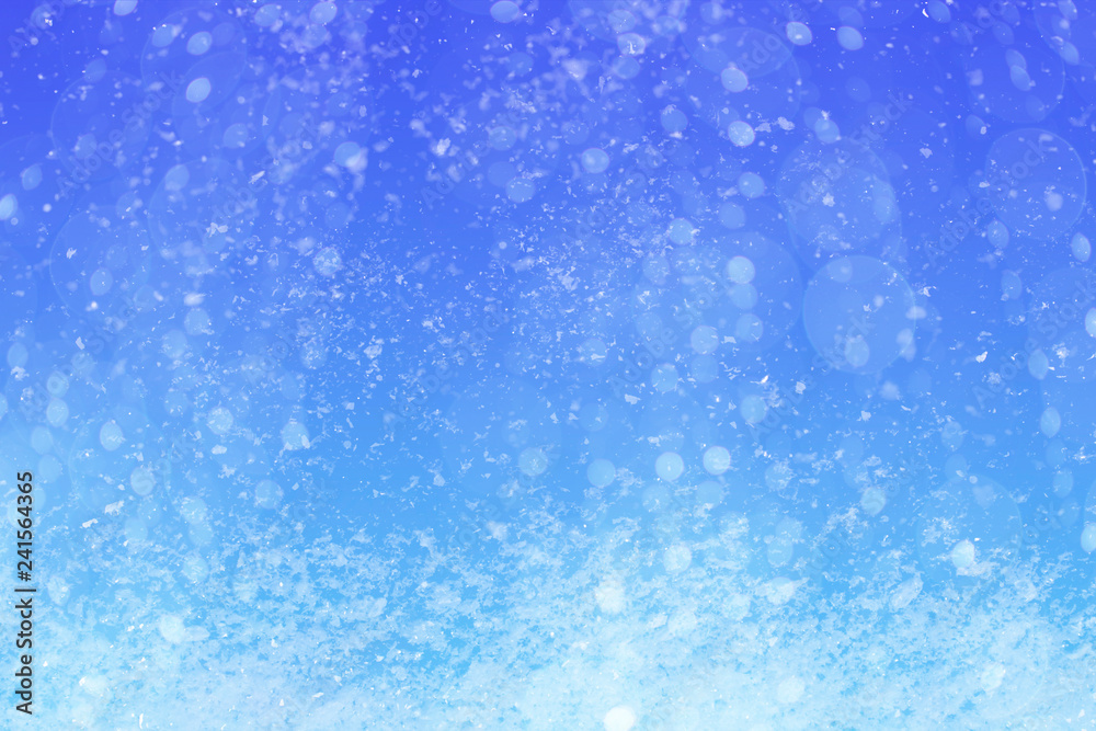 Winter blue sky with falling snow.